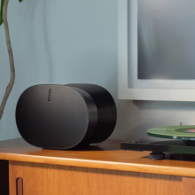 black Sonos Era 300 speaker sitting next to record player on table