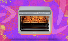 Ninja air fryer arranged on swirly orange and purple Prime Day themed backdrop