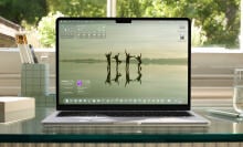 A photograph of a Mac laptop displaying the new MacOS 26 operating system. 