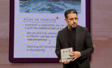 A person on a stage with the Kindle Scribe Colorsoft