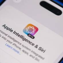 A photograph of an iPhone displaying a beta version of Apple Intelligience-powered Siri