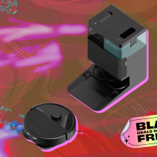 iRobot Roomba 405 robot vacuum heading toward Auto Empty Dock, arranged on pink backdrop with "Black Friday" tag in corner