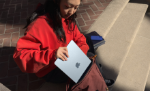 a woman placing a 13-inch m4 apple macbook air into a backpack