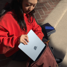 a woman placing a 13-inch m4 apple macbook air into a backpack