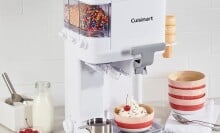 the Cuisinart Mix It In Soft Serve Ice Cream Maker  with various ice cream and toppings around the machine