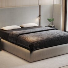 the eight sleep pod bed system on a mattress in a bright and clean bedroom 