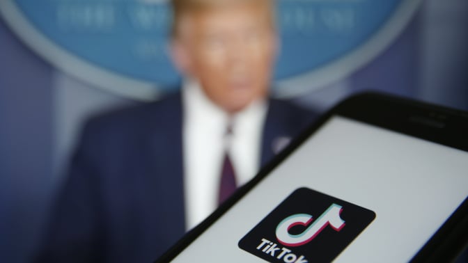 TikTok logo on mobile device and Donald Trump