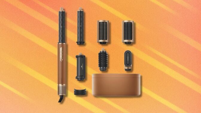 the Dreame AirStyle Pro with accessories on an orange background