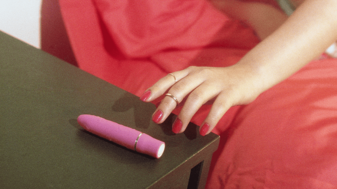Woman reaching for bullet vibrator. 