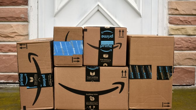 Amazon packages stacked up on front porch