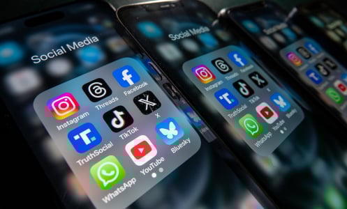  iPhone screens display various social media apps on the screens