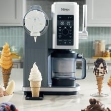 ninja swirl on kitchen counter surrounded by cones and bowls of ice cream and soft serve