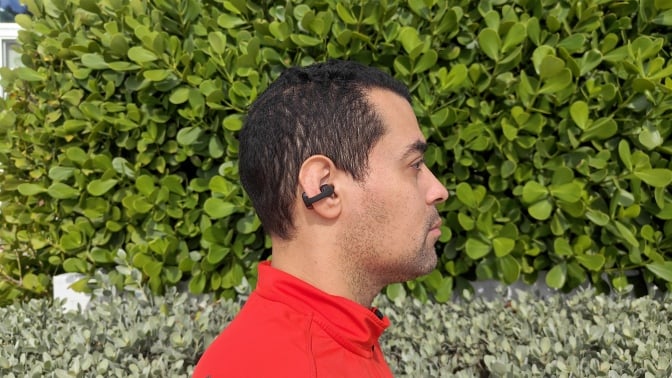 The author wearing the clip-on Shokz earbuds