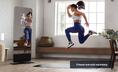 Woman jumping in front of a fitness mirror