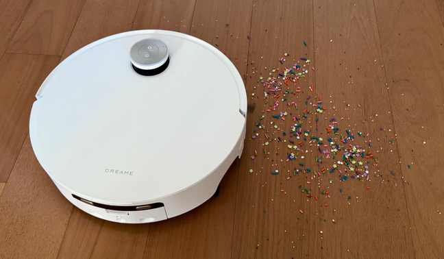 Dreame Aqua10 Ultra Roller robot vacuum cleaning sprinkles on hardwood floor