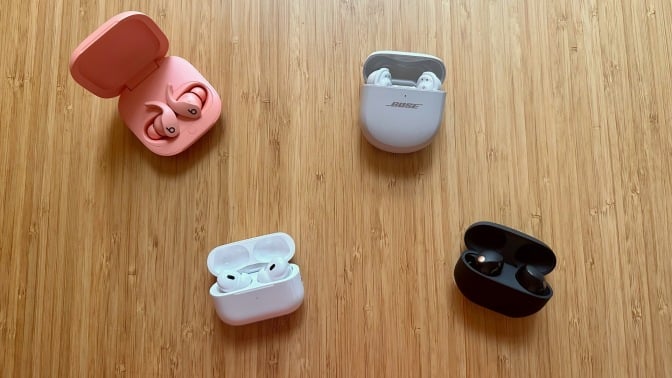 four pairs of earbuds on a table