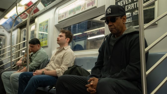 Denzel Washington sits listening to music on the New York subway in the film "Highest 2 Lowest"