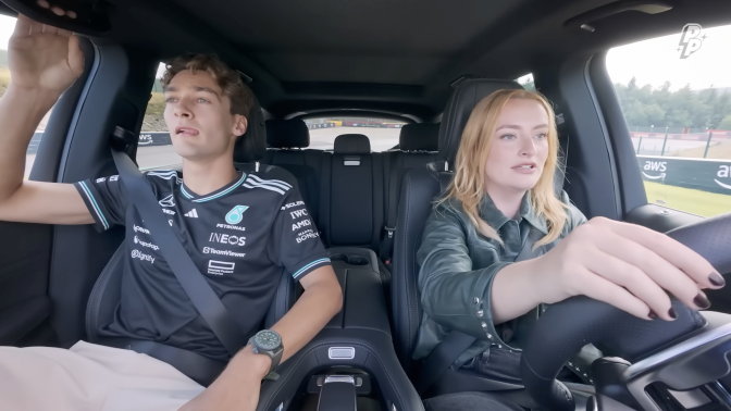 A man and a woman sit in a car.