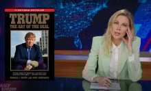 A man sitting behind a talk show desk puts her head in her hand, looking weary. On the left is an image of Trump's "The Art of the Deal" book.