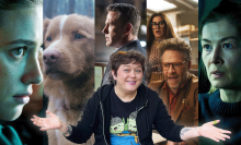 a woman smiling with open arms in front of a collage of movie posters