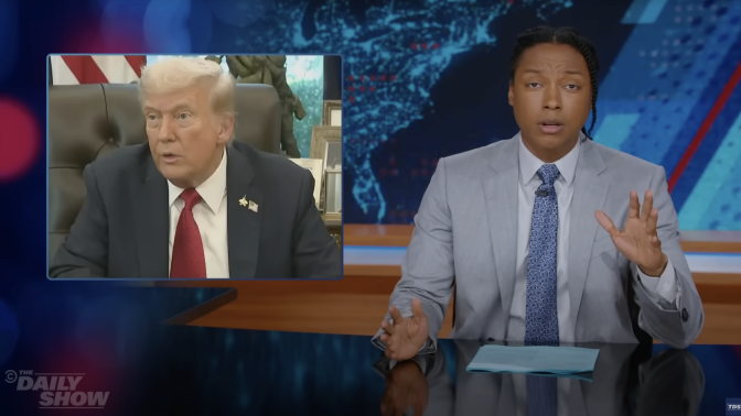 A man in a suit sits behind a talk show desk. In the top left is an image of the president sitting in the Oval Office.