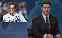 White man in suit and tie at a news desk