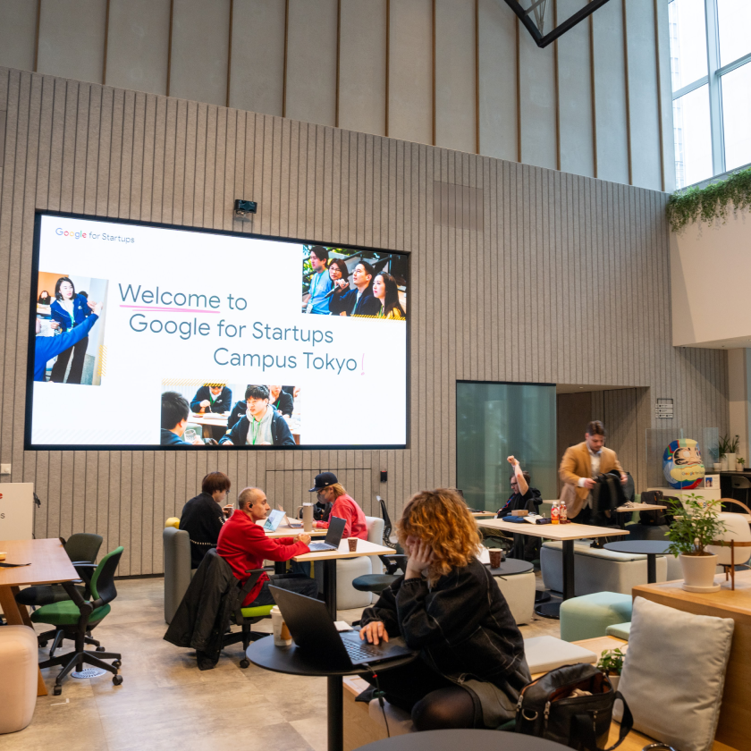 Some people seated around the tables in the Campus Tokyo event.
