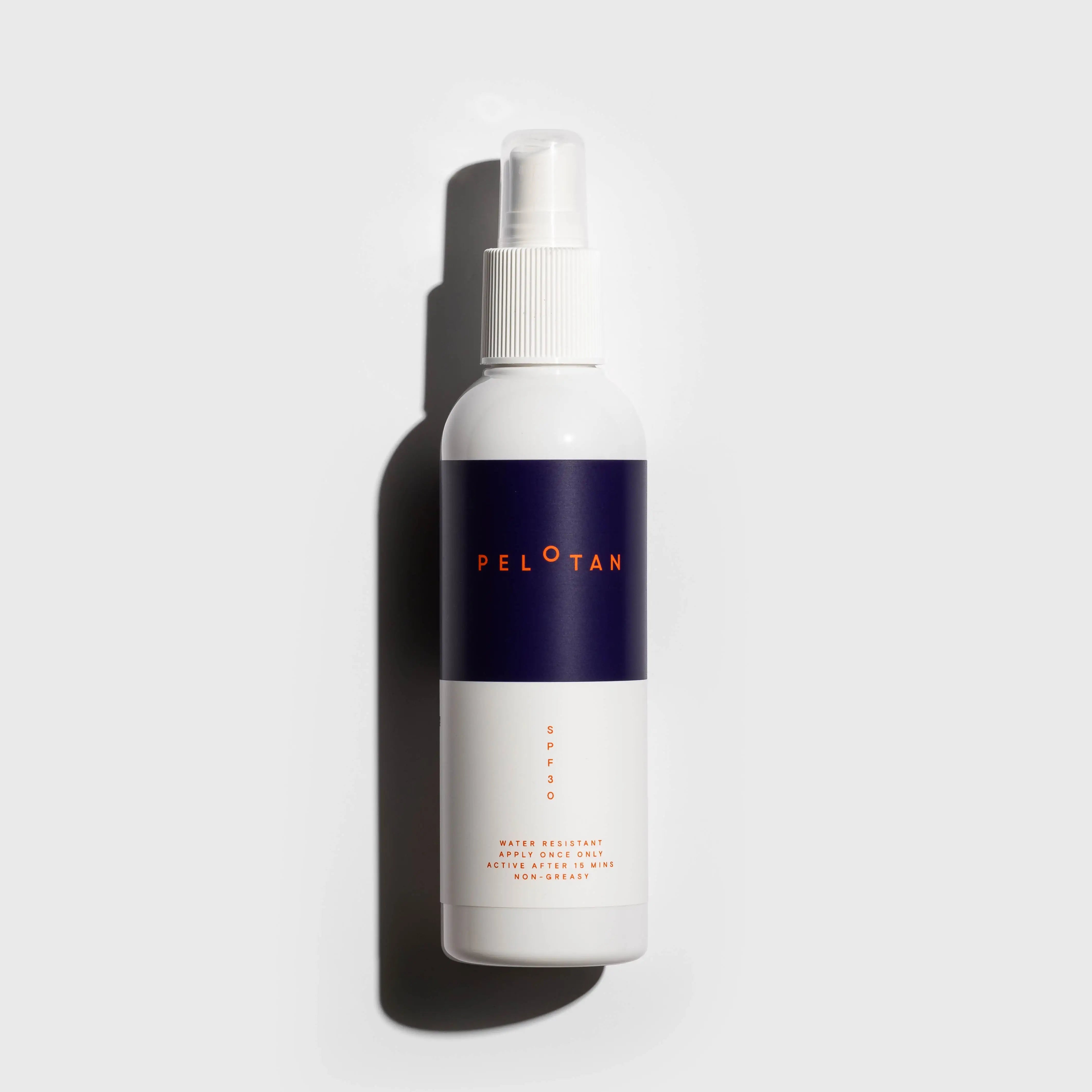 A flat-lay of the Pelotan 200ml spray bottle of sports sunscreen on a white background.