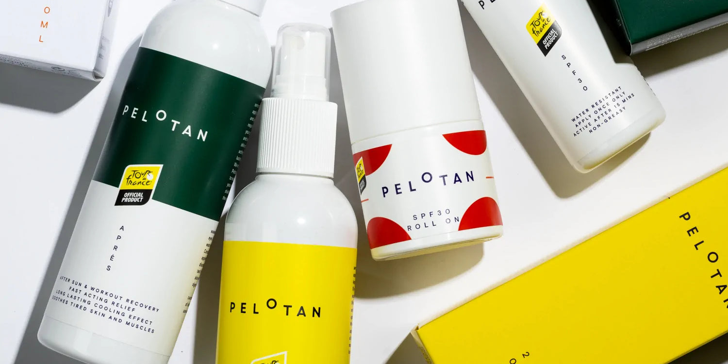 Bottles of Pelotan’s recovery and performance sunscreen products are laid on a white background, showing products that are official products of the Tour de France.