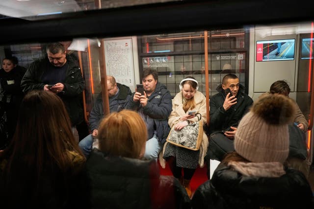<p> Passengers look at their smartphones while on the subway in Moscow, Russia, March 4, 2025. (AP Photo/Alexander Zemlianichenko, File)</p>